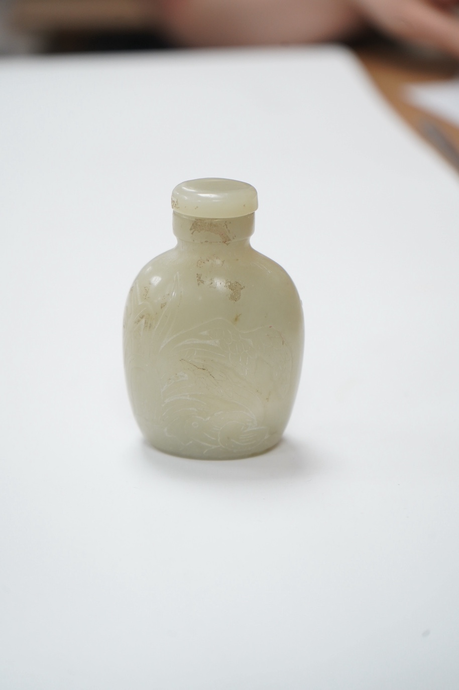 A Chinese carved jade snuff bottle with stopper, 7cm high including stopper. Condition - good